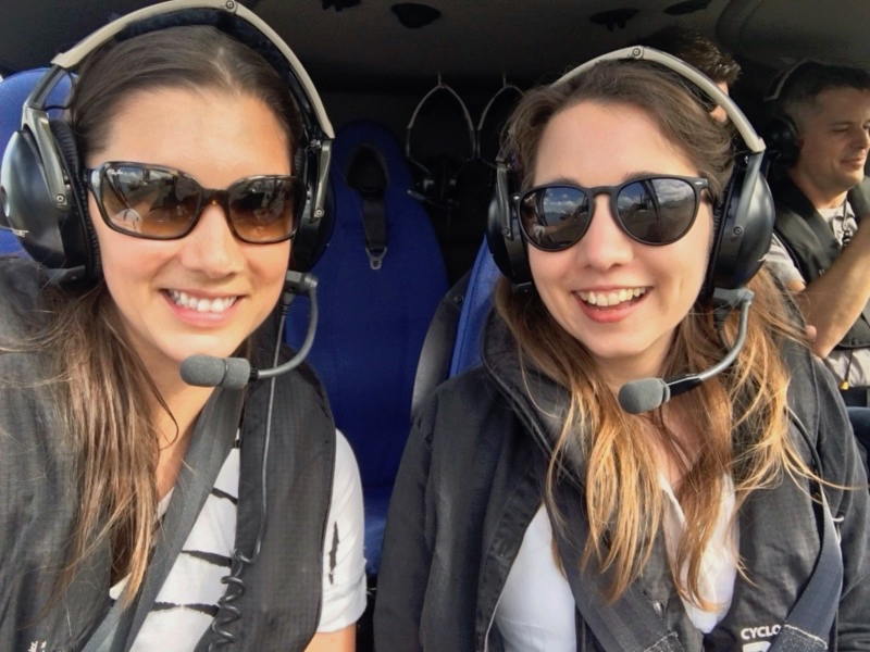 Me and my sister Emily sitting smiling in a helicopter.