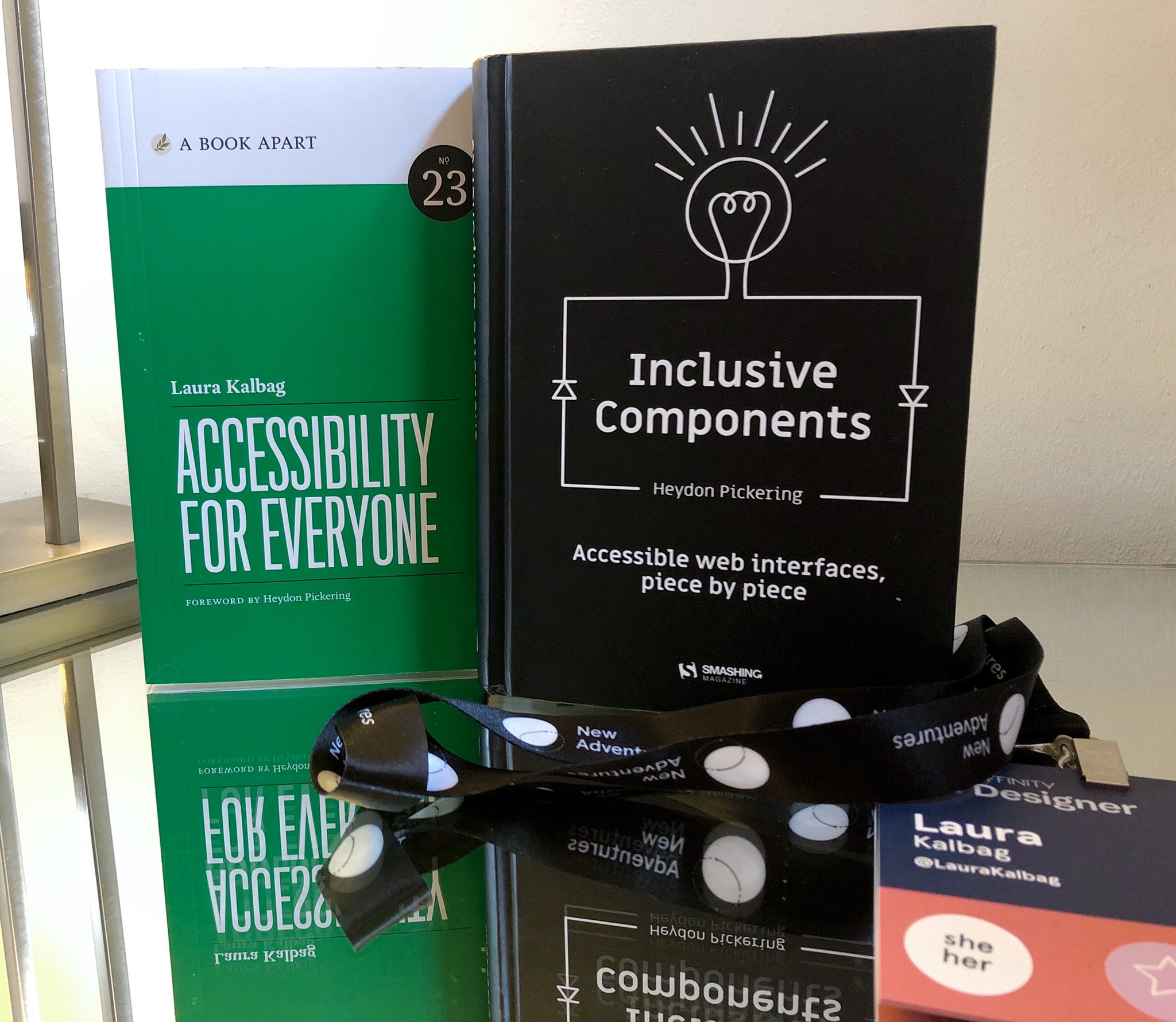 Accessibility For Everyone book by Laura Kalbag, Inclusive Components book by Heydon Pickering and my New Adventures lanyard.