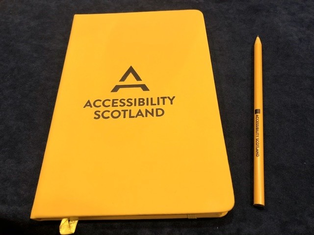 Accessibility Scotland branded notebook and pencil.