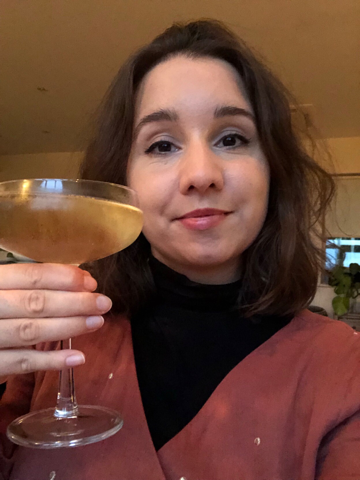 Selfie of me with a saucer glass of champagne.